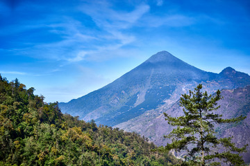 Fototapeta premium Santa María Volcano behind a valley / This is a large active volcano in the western highlands of Guatemala next to the city of Quetzaltenango