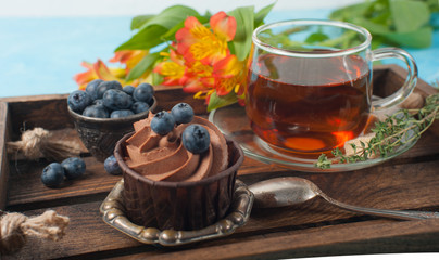 cupcake with tea on a blue background