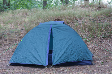 Tourist camping tent in the woods