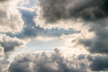 Naklejka na ściany i meble Abstract background, blue sky with dark cumulonimbus clouds.