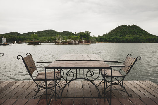 Antique wooden chairs on the river.