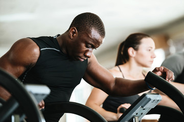 Afro american sportsman exercising on a treadmill at the gym