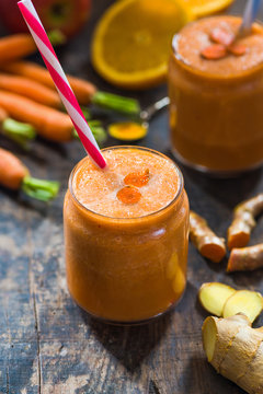 Fresh smoothie with carrot, apple, orange, banana, ginger and turmeric root
