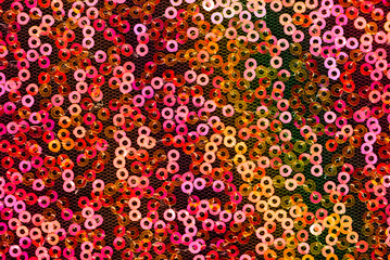 sequins pattern texture. Red, orange and pink round sequins background.   sequins texture.