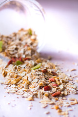 Plate of homemade muesli with cornflakes, Goji berries, chia seeds, freezedried apricot, sunflower seeds, cinnamon.