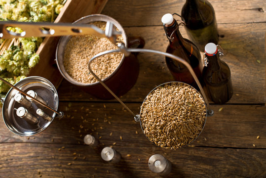 Man Weighs Malt For Home Brewing Of Beer. Top View.