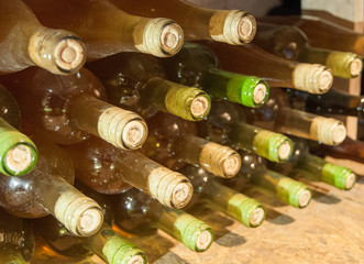 bottles with wine stacked in rack