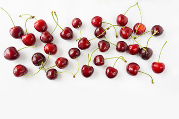 Naklejka na ściany i meble Ripe cherry on a white background. Cherries with copy space for text. Top view.