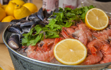 shrimp with mussels and lemon on ice