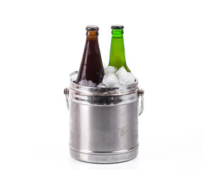 Beer in a bucket of ice on a white isolated background