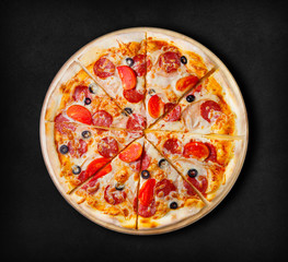 Pepperoni pizza on a black background.  Visit my page. You will be able to find an image for every pizza sold in your cafe or restaurant 