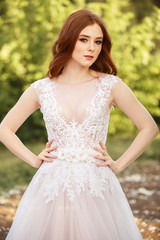 Fototapeta premium Beautiful redhead Bride. Portrait outdoor in sunset light. Pretty young caucasian redhead girl