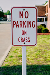 No parking on grass sign close up