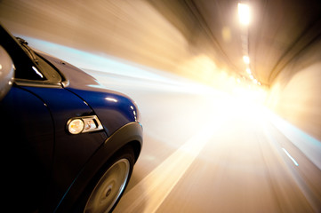 Fototapeta na wymiar Blue Mini S Coupé Car, Speeding Through The Night