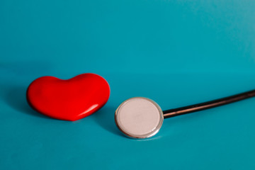 Red heart and stethoscope on table, world health day and healthcare concept.