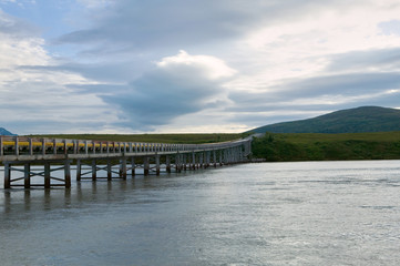 Obraz na płótnie Canvas A road bridge over a glacial river in Alaska