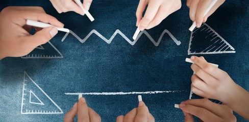 Composite image of business people writing with chalks