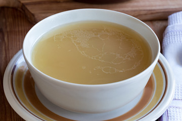 Chicken bone broth served in a soup bowl