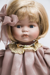 Ceramic porcelain handmade doll with blond hair and pink dress