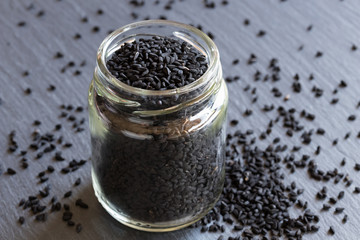 Fototapeta na wymiar Black cumin seeds in a glass jar
