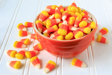 Candy corn in a ceramic bowl.