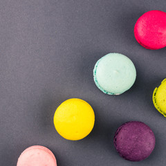 Colourful french macaroons on the grey background, Top view. Square