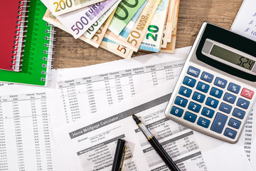 finance paperwork, euro bills, pen nad calculator at office