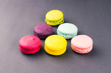 Colourful french macaroons on the grey background