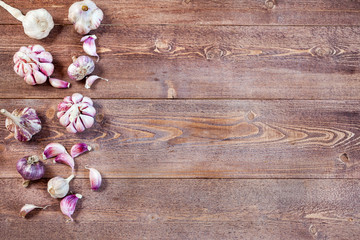 Fototapeta na wymiar Garlic. Garlic Cloves and Garlic Bulb on a wooden vintage rustic table. Top View. Copy Space
