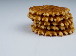 homemade Belgian waffles with powdered sugar on black background, very tasty snack. sugar old white wooden table. bright rustic style. copy space for text, stylish, light background