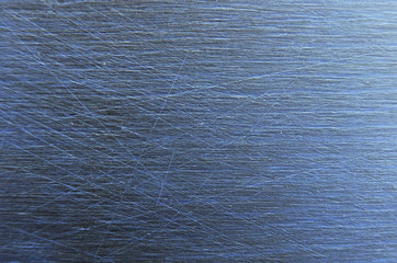 Metallic background. Aluminum texture with scratches. Blue gleam