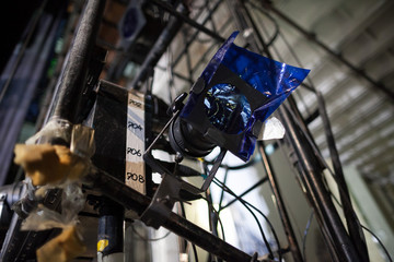 hardware, perfomance, backstage concept. there is important technical equipment of theater's backstage like spotlight with blue filter for creating dreamy and mysterious atmosphere