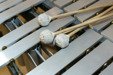 xylophone, musical percussion instrument concept - closeup on wooden beige bars with mallets, glockenspiel, marimba, balafon, semantron, pixiphone, education and orchestra concert usage
