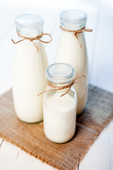 bottles of milk on a wooden rustic table.