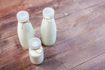 bottles of milk on a wooden rustic table. copy space