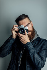man takes photo with film camera