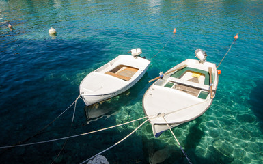 Fototapeta na wymiar Boats in clear blue sea in summer time