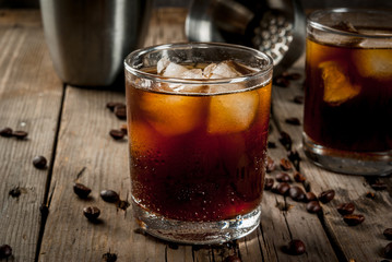 Alcohol. Drinks, Boozy Black Russian cocktail with vodka and coffee liquor on rustic wooden table. copy space