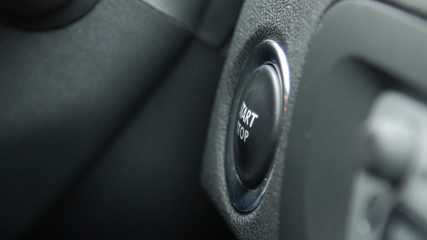 Close up of engine start and stop button of a car.