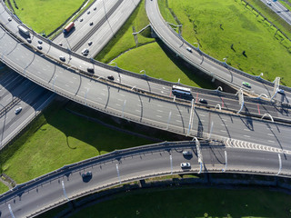 Multi-level interchange of city ringroad with driving vehicles. Aerial view. St. Petersburg, Russia