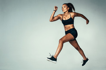 Fototapeta na wymiar Hispanic female model doing running exercise
