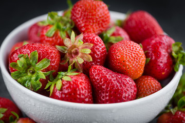 Some Strawberries on a dark slate slab