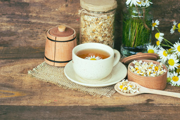 cup of herbal chamomile tea with camomile dry blossoms, dried camomile flowers. doctor treatment and prevention of immune concept, medicine - folk, alternative, complementary, traditional medicine 