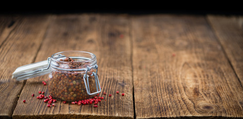 Portion of Pink Peppercorns (preserved) , selective focus
