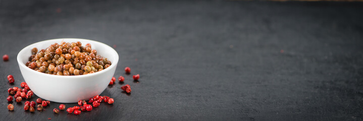 Portion of Pink Peppercorns (preserved) , selective focus