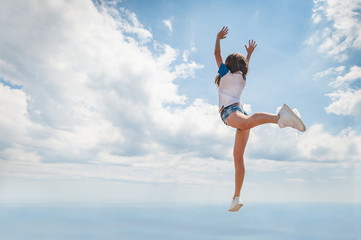 Girl jump over the sea