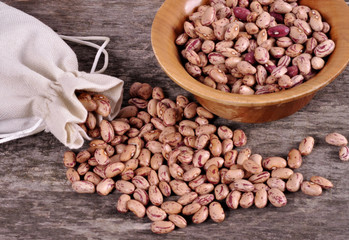 Sack of mix beans spill beans with beans on wooden table