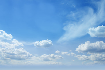 Blue sunny skies partial with clouds background. Photo.