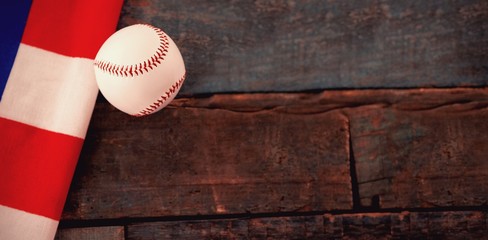 Baseball ball and American flag on table