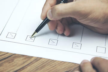 businessman preparing checklist at office desk